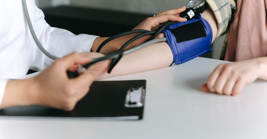 A healthcare worker uses a sphygmomanometer to check a patient's blood pressure in a medical office.