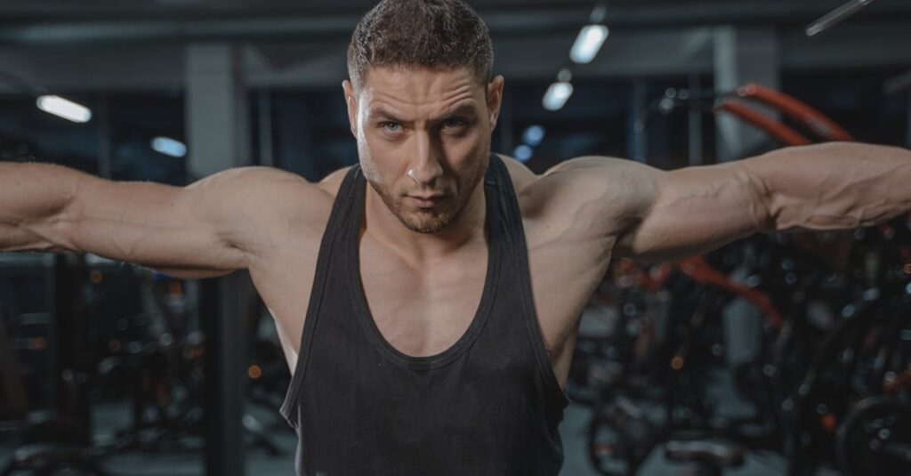 Focused man in activewear exercising in a gym environment.