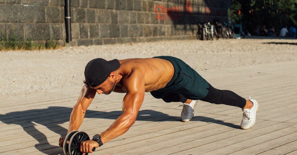 Fit man in outdoor workout using ab roller, showcasing strength and fitness.
